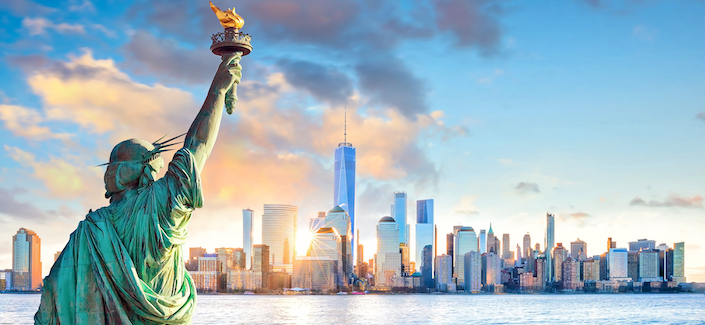 Statue Liberty and  New York city skyline at sunset